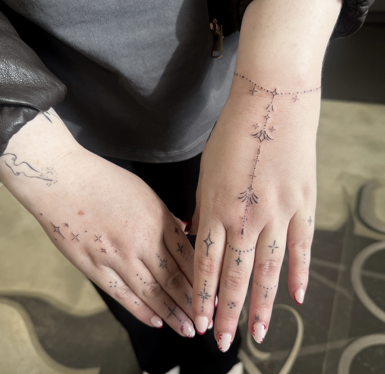 Fineline ornamental hand tattoo